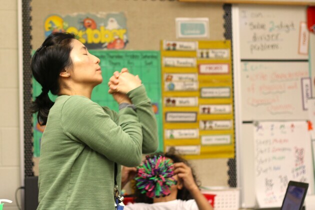 César E. Chávez Elementary School teacher Sung Pak joins her students in a breathing exercise meant to transition students from recess to learning