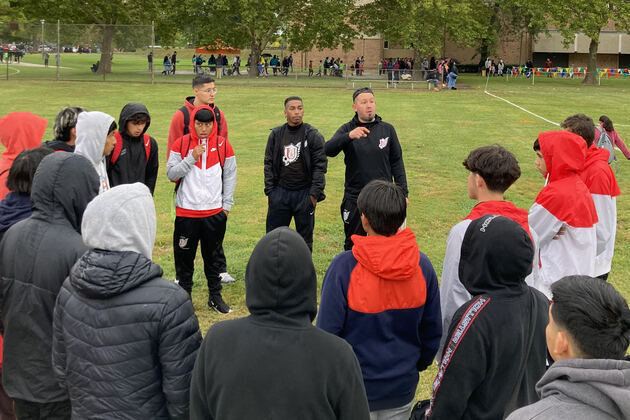 Union soccer coach Juan Zavala (right) and Union assistant coach Mose Crawford pump their players up prior to the first of four fall soccer sessions for GRPS elementary school students