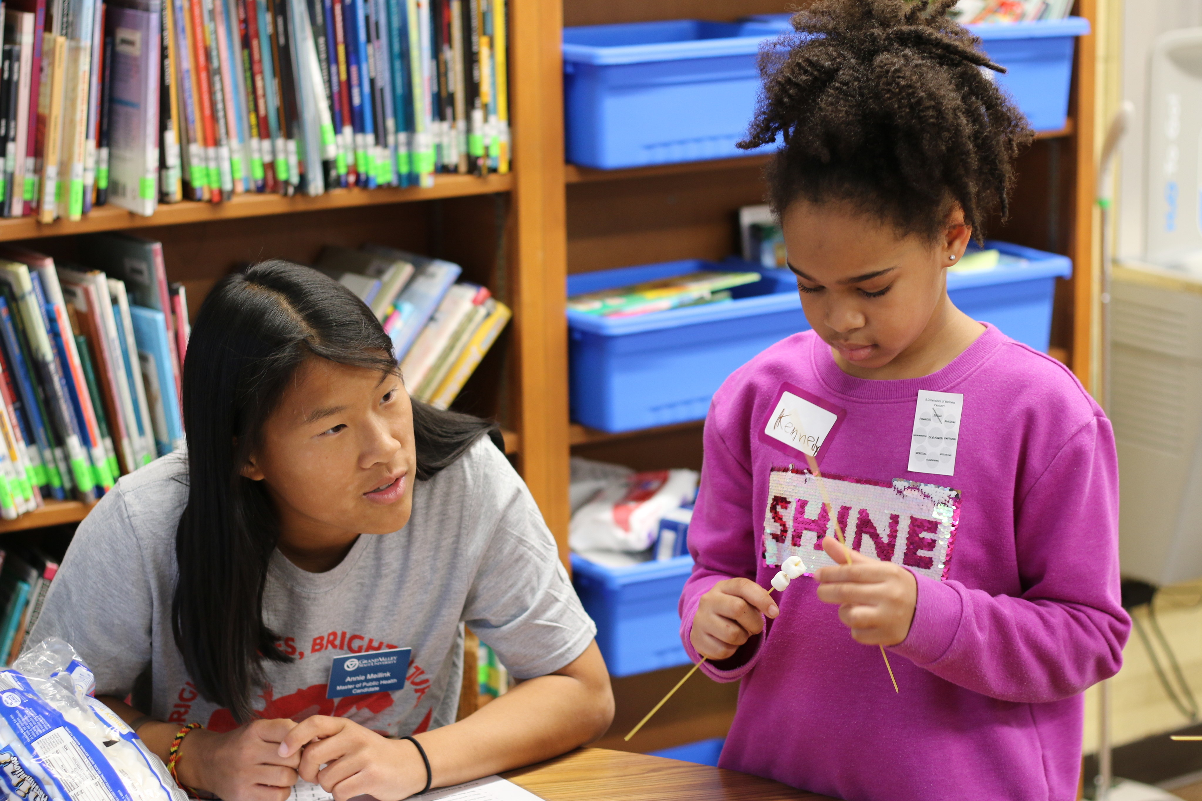 A GVSU public health student master’s student works with a scholar at Mulick Park Elementary