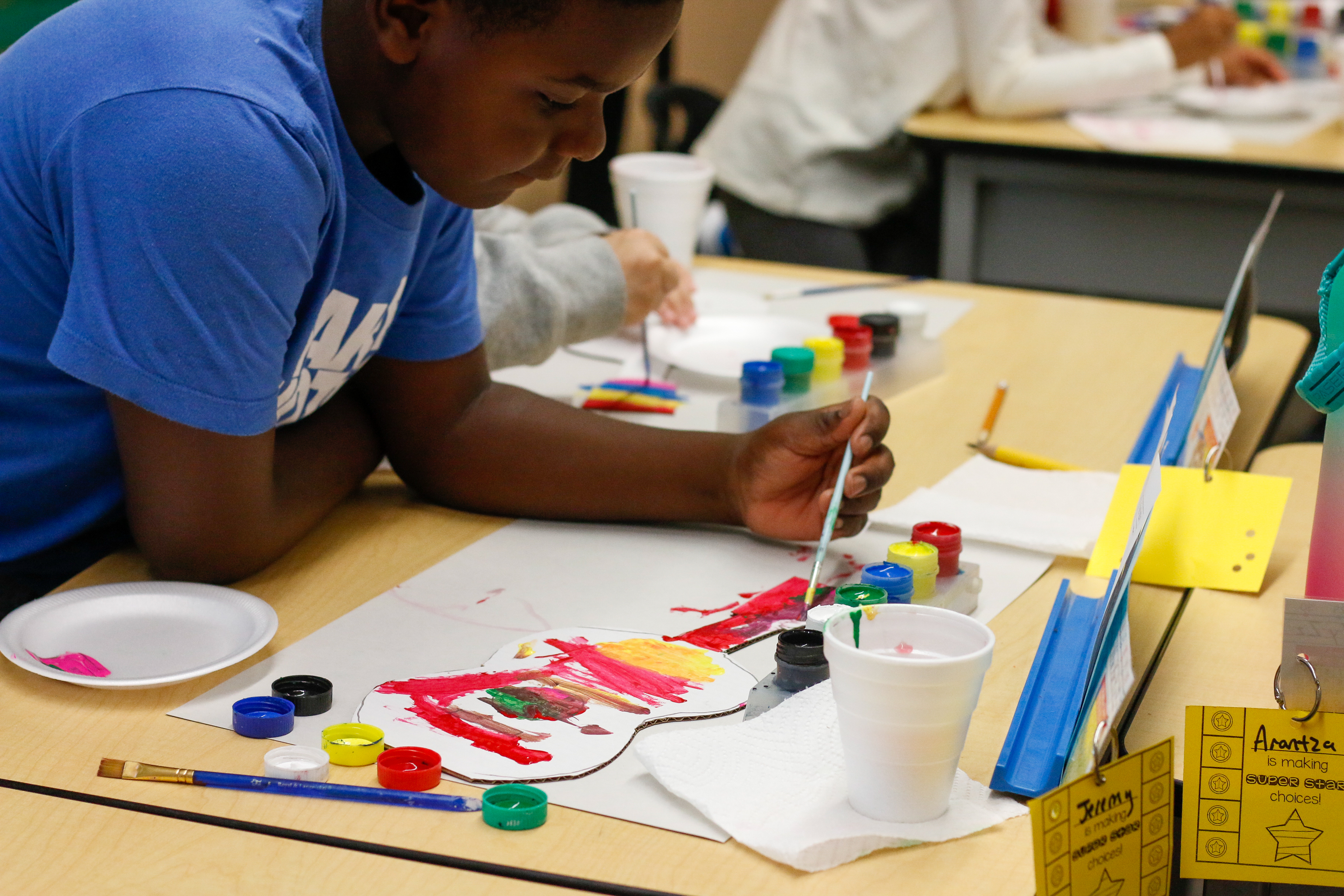 A Sibley Elementary scholar works on his art project
