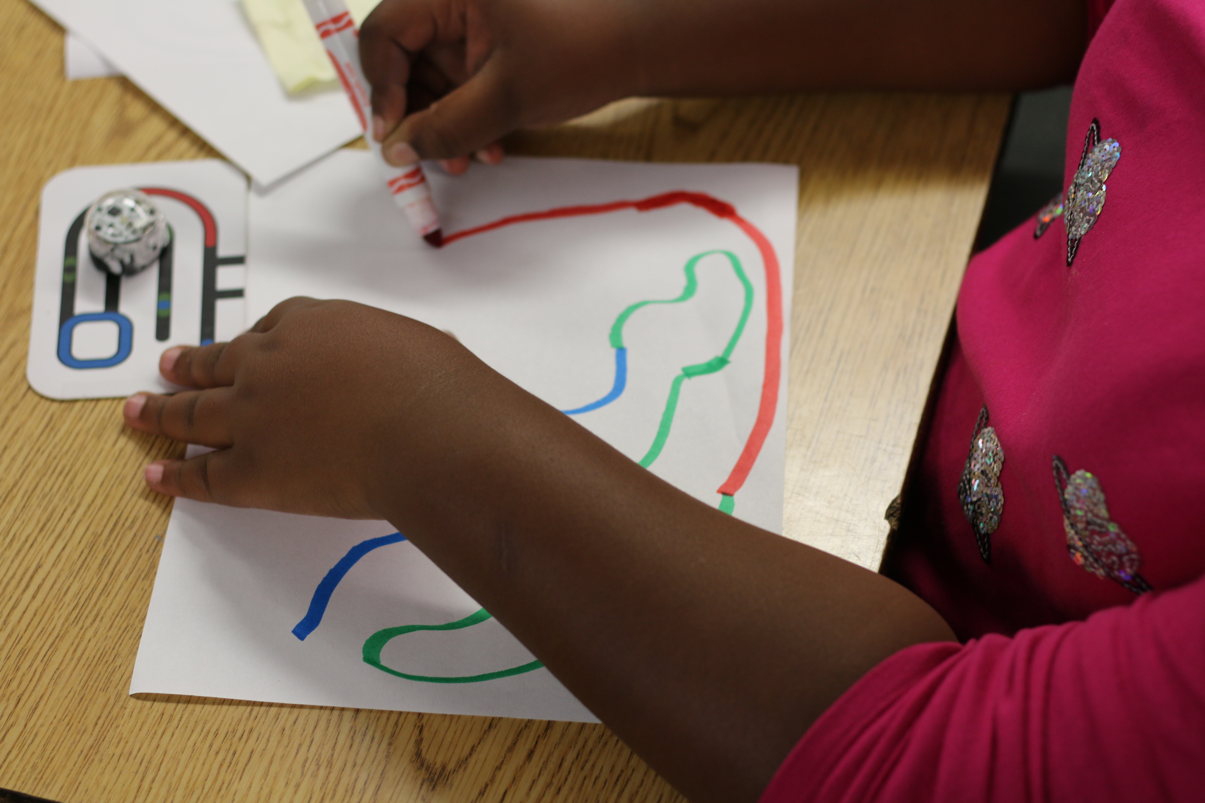 A student at Shawmut Hills works on her Ozobot code