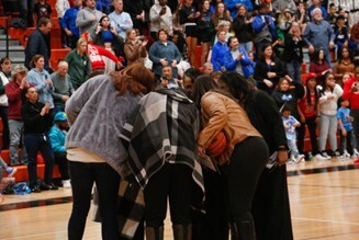1989 girls basketball state champion team go in for their team huddle